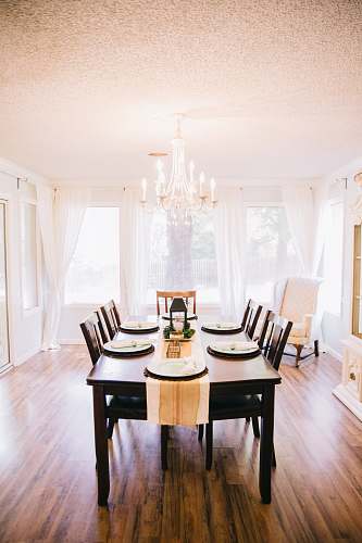 interior design rectangular brown wooden table with tabled near window indoors